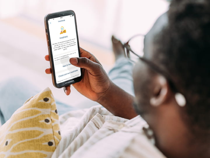  Male customer looking at his investments in Barclays Smart Investor on a mobile phone